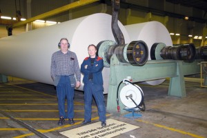 Roland Lindström and Ulf Ahlstrand by the 8.4 meter paper rolls that are then cut down into the required widths and supplied to printers and newspaper publishers.